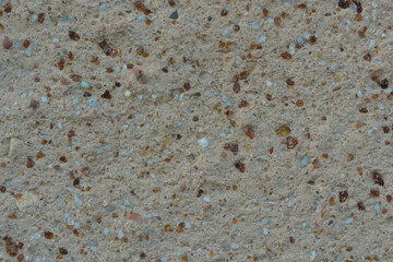 the texture of a concrete wall interspersed with glass of different colors