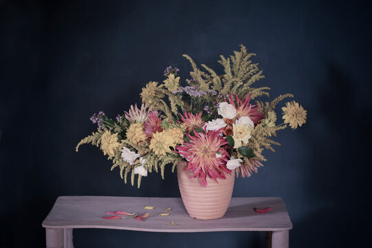 Yellow And Red Flowers In Vase On Vintage Shelf