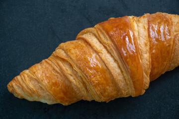 Croissants are placed in black plate