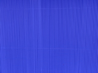 blue color metal plate Siding. Seamless surface of galvanize steel. Industrial building wall made of corrugated metal sheet, flat background photo texture.
