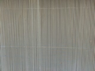 aluminium color metal plate Siding. Seamless surface of galvanize steel. Industrial building wall made of corrugated metal sheet, flat background photo texture.