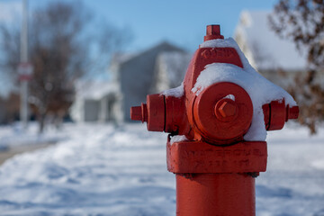 Red fire hydrant with snow on a totally snowy street