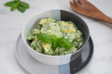 Italian Tortellini with spinach and basil on a table
