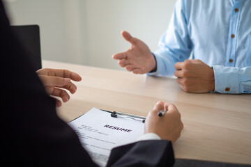 Obraz premium Businessmen are inquiring about job applicants' CVs and interviews about past work experiences. Boss is recruiting employees for the company. Concept of Resume
