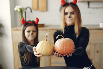 Fototapeta premium Halloween. Mother and daughter in halloween costume. Family at home.