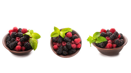 Raspberry, blackberry and mint leaf in ceramic brown bowl isolated on white