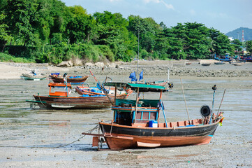 Thai's fishing boat lay on a beach