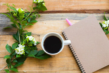 notebook planner for business work with hot coffee espresso ,flower jasmine arrangement flat lay style on background wooden