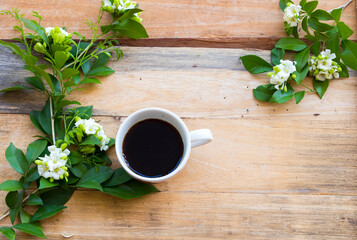 hot coffee espresso with flowers jasmine arrangement flat lay style on background wooden