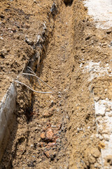 Digging road before install Pipe Water. Excavation water drainage at construction site. Digging roads to lay pipes 8 inches. The road repair and caution with blocked barrier over concrete digging.