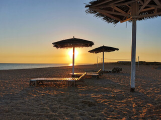 Beautiful view of the sunset over the sea and deserted beach. Bugazskaya spit, Anapa, Russia.