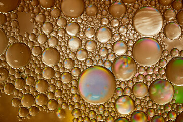 Artistic photo of oil drops close up in brown tones for background