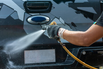 People cleaning car with high pressure water - 376835118