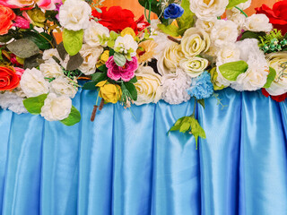 Fake roses and elegant blue fabric