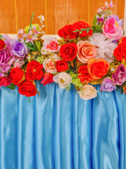 Fake roses and elegant blue fabric