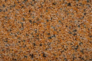 textural plaster of the house wall, colored granite chips, background