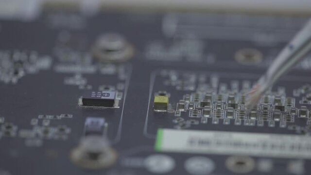 Cleaning A Motherboard And Its Components With A Small Paint Brush - selective focus
