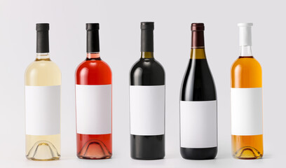 Bottles of wine with blank labels on light background. Mockup for design