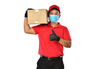 Fototapeta na wymiar Happy young Asian delivery man in red uniform, medical face mask, protective gloves carry cardboard box in hands isolated on white background. Delivery guy give parcel shipment. Safe delivery