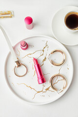 Beautiful lipsticks, coffee and bijouterie on table