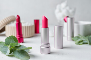 Different beautiful lipsticks on table