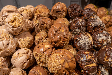 Traditional German sweet balls in with chocolate, almonds, and peanuts for sale at the traditional Christmas market
