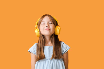 Little girl listening to music on color background