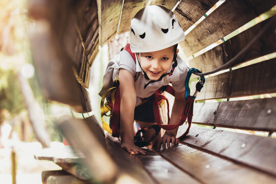 Brave Little Boy Having Fun At Adventure Park