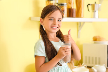 Obraz na płótnie Canvas Little girl drinking tasty chocolate milk at home