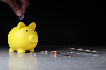 Yellow pig piggy bank is saving with coin money placed on the table (financial planning concept)