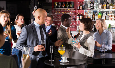 Portrait of man having fun and talking to woman on corporate party