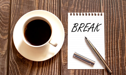 BREAK- white paper with pen and coffee on wooden background