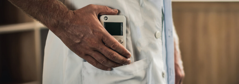 Young man hands hold bio rezonans therapy alternative medicine device, small portable life balance bioresonance for treatment Diseases of the intestinal system