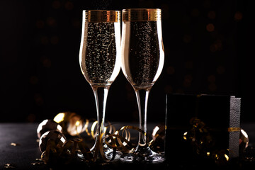 selective focus of glasses full of champagne against christmas lights