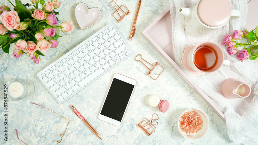 Wall mural blush pink theme cosy hygge desktop workspace with keyboard smart phone tea and rose on a stylish wh