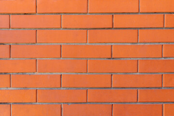 Red color brick wall for brickwork background design. Background of stone wall texture