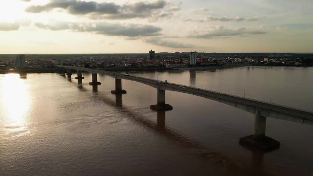 Kizuna bridge with traffic over the mighty Mekong, drone lift shot.  Cambodia.