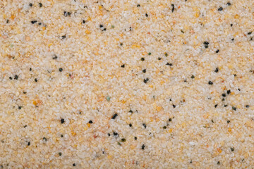 textural plaster of the house wall, colored granite chips, background