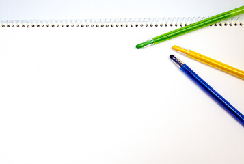 White-bottomed sketchbooks and various colored pencils