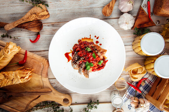 Fried Fish Fillet On Vegetable Saute In Red Sauce