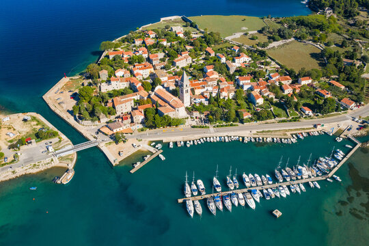Beautiful old historic town of Osor, marina and bridge connecting islands Cres and Losinj, Croatia, aerial view from drone