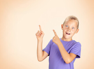 Funny surprised boy pointing with hand and finger