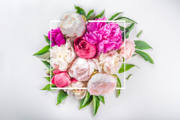 Flat lay of flowers and green leaves