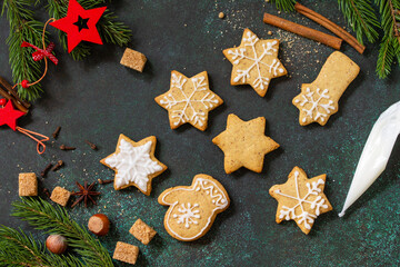 Christmas pastries. Gingerbread cookies on a background of stone or slate. Top view flat lay background. Copy space.
