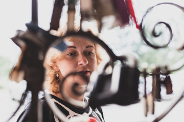 Woman examines the locks on the gate