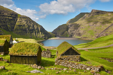 Picturesque green landscape with black houses in Faroe islands. Saksun