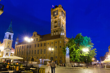 View of Old Town Hall of Torun and monument of Nicolaus Copernicus in night lights, Poland