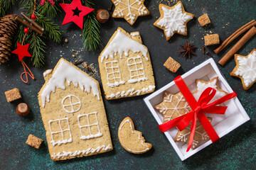 Christmas baking. Homemade Gingerbread cookies in a gift box on a stone or slate background. Top view flat lay background.