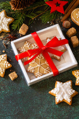 Christmas baking. Gingerbread cookies in a gift box on a stone or slate background.
