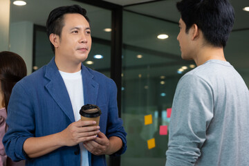 Asian Startup business man  standing and talk about job in morning.